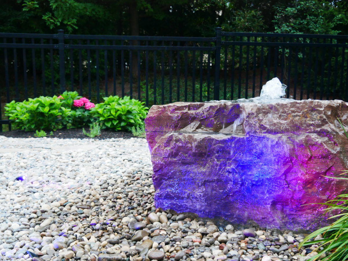 multicoloured rock fountain with small stones